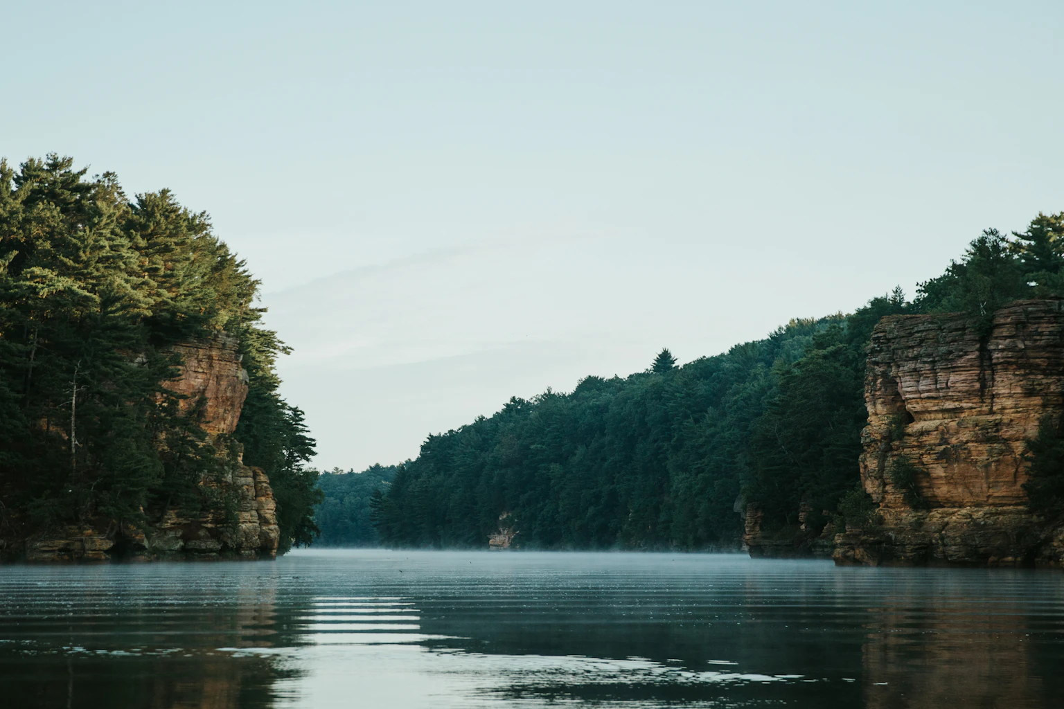 The Wisconsin River between wooded sandstone cliffs in Wisconsin Dells.